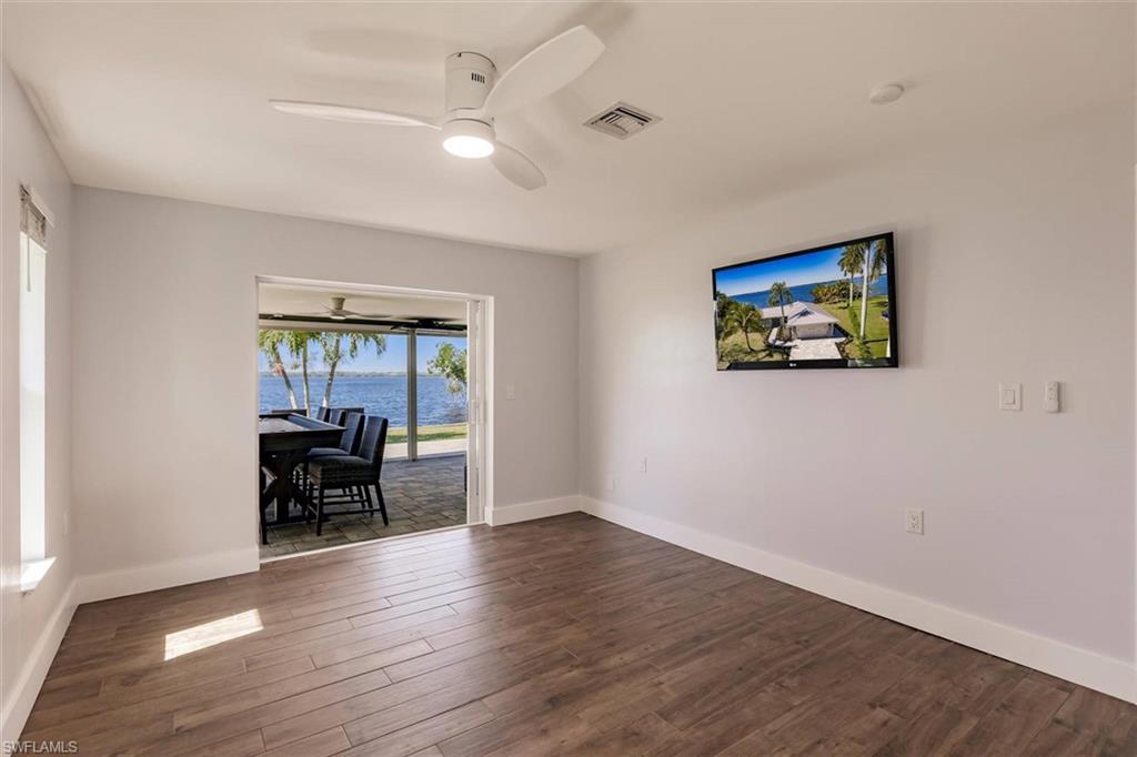 138 Riverview Road Fort Myers, FL 33905 - Photo 24 of 50 Empty room with a ceiling fan, baseboards, visible vents, and dark wood-type flooring