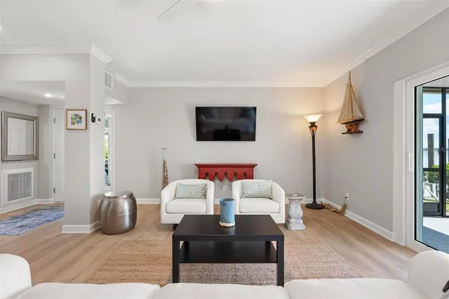 a living room with furniture a rug and a flat screen tv