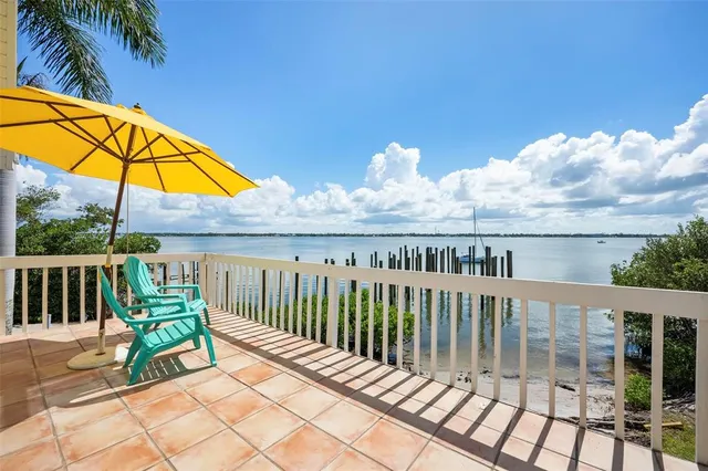 a view of a chair and table on the deck