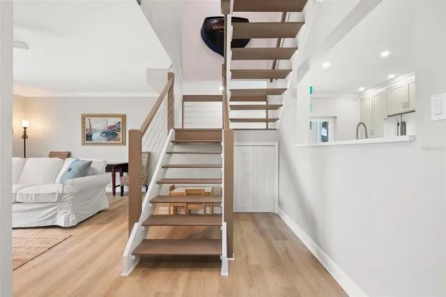 a view of entryway and hall with wooden floor