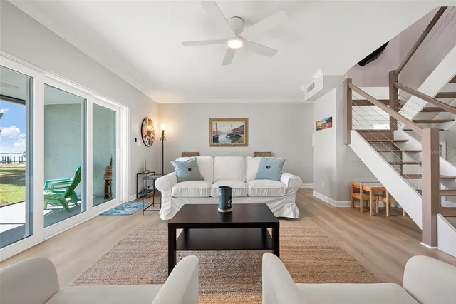 a living room with furniture a rug and white walls