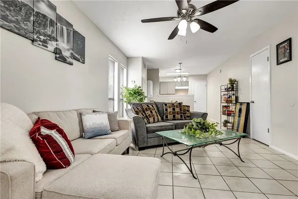 a living room with furniture and a ceiling fan