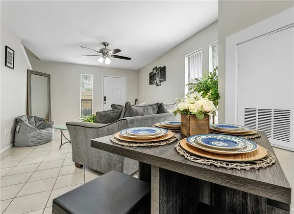 a dining room with furniture and a potted plant
