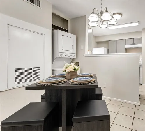 a view of a dining room with furniture and chandelier