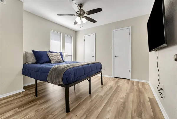 a bedroom with a bed and a flat screen tv