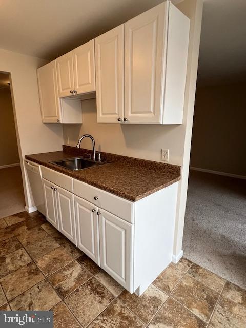 18120 Chalet Drive, Unit 11301 Germantown, MD 20874 - Photo 4 of 15 a kitchen with granite countertop white cabinets and a sink
