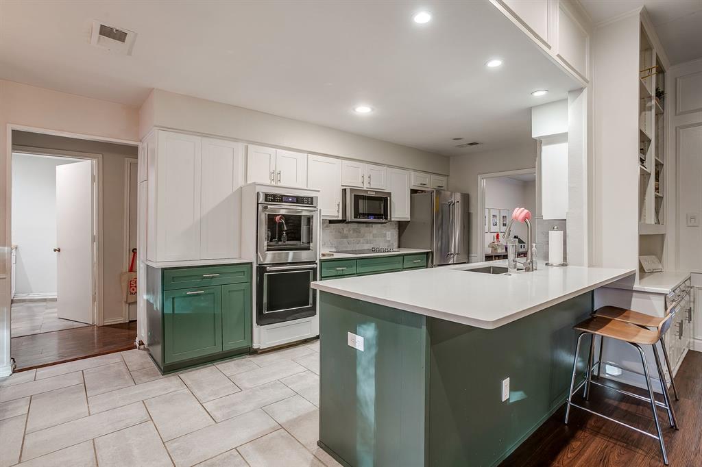1804 Longbranch Court Arlington, TX 76012 - Photo 11 of 33 a kitchen with a sink a microwave and cabinets