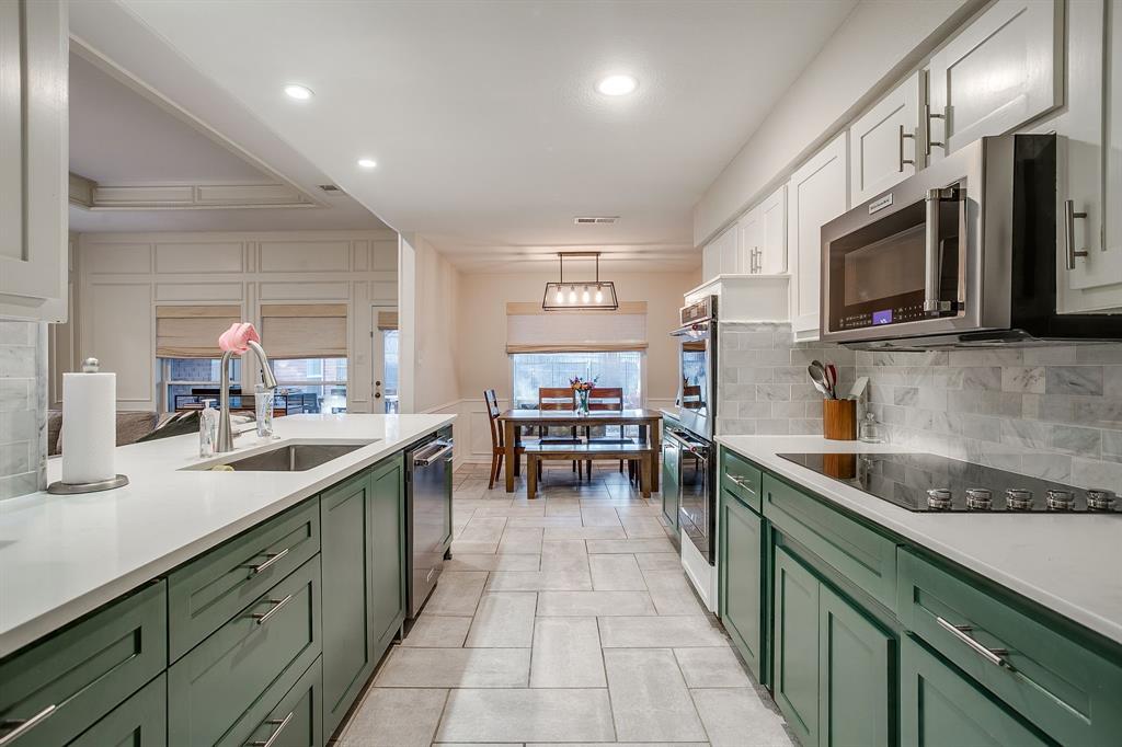 1804 Longbranch Court Arlington, TX 76012 - Photo 12 of 33 a kitchen with stainless steel appliances granite countertop sink stove and microwave