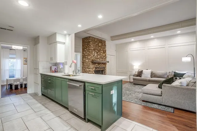 a view of a dining room with furniture a chandelier and wooden floor
