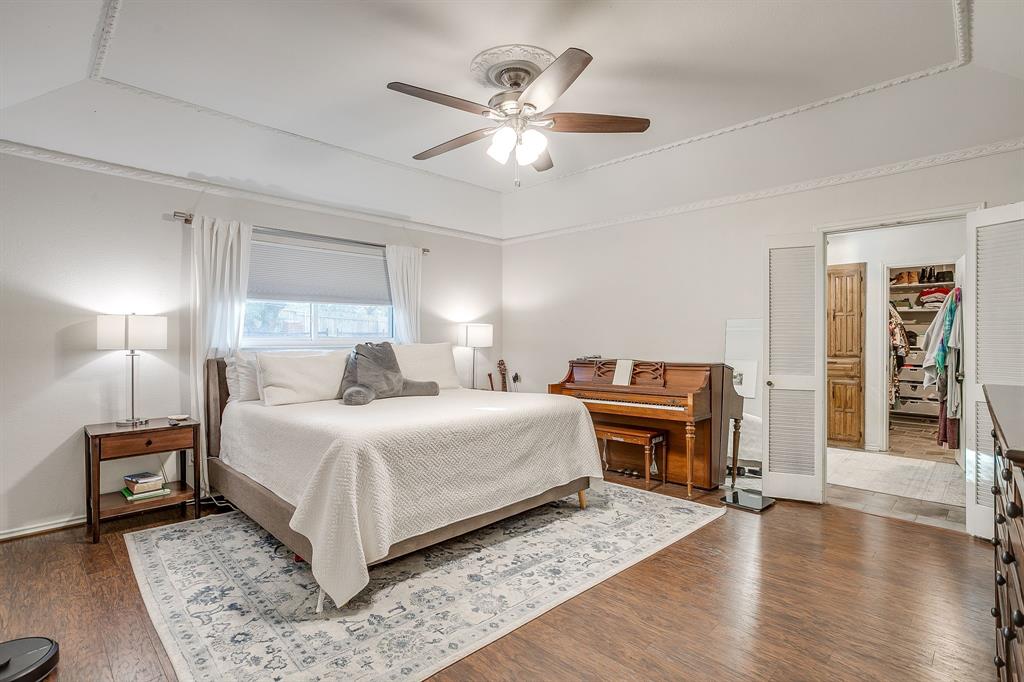 1804 Longbranch Court Arlington, TX 76012 - Photo 15 of 33 a bedroom with a large bed and a chandelier