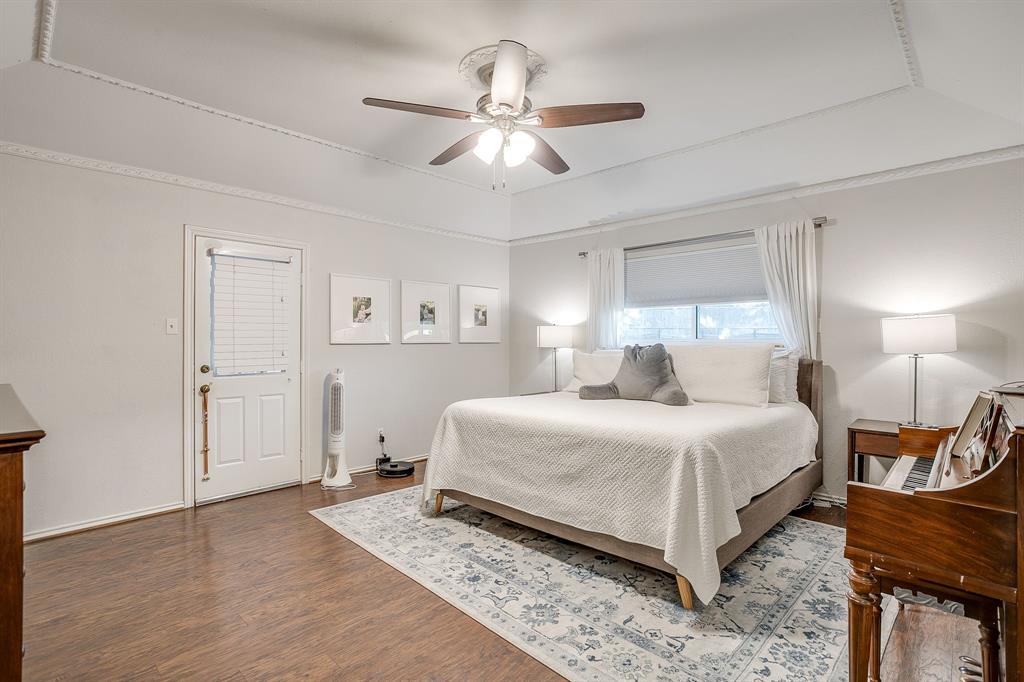 1804 Longbranch Court Arlington, TX 76012 - Photo 16 of 33 a bedroom with a bed and a chandelier