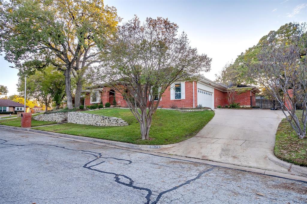 1804 Longbranch Court Arlington, TX 76012 - Photo 2 of 33 a front view of a house with a yard and potted plants