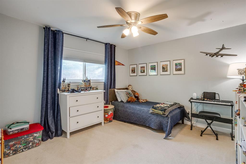 1804 Longbranch Court Arlington, TX 76012 - Photo 23 of 33 a bed room with a bed window and a chair