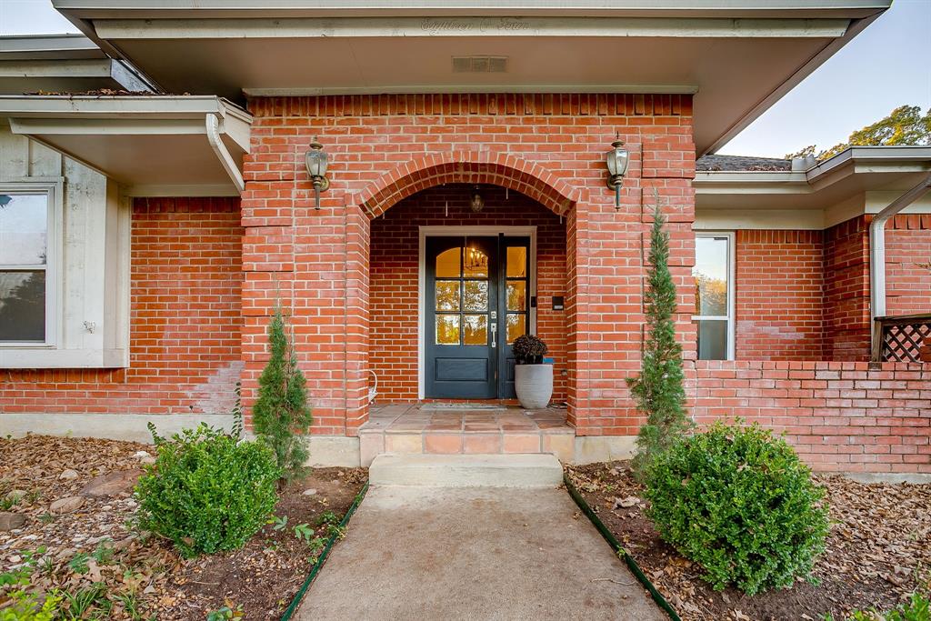 1804 Longbranch Court Arlington, TX 76012 - Photo 3 of 33 a front view of a house with a porch