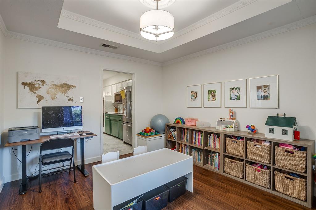 1804 Longbranch Court Arlington, TX 76012 - Photo 6 of 33 a bedroom with furniture a rug and a wooden floor