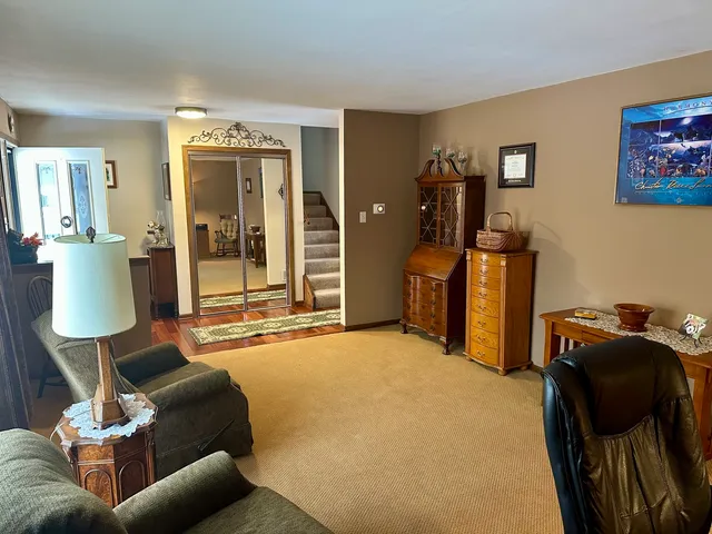 a living room with furniture and a lamp