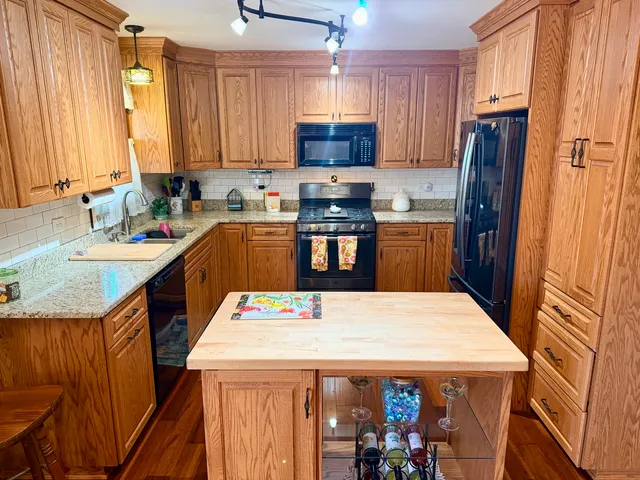 a kitchen with a refrigerator a stove top oven a sink and dishwasher
