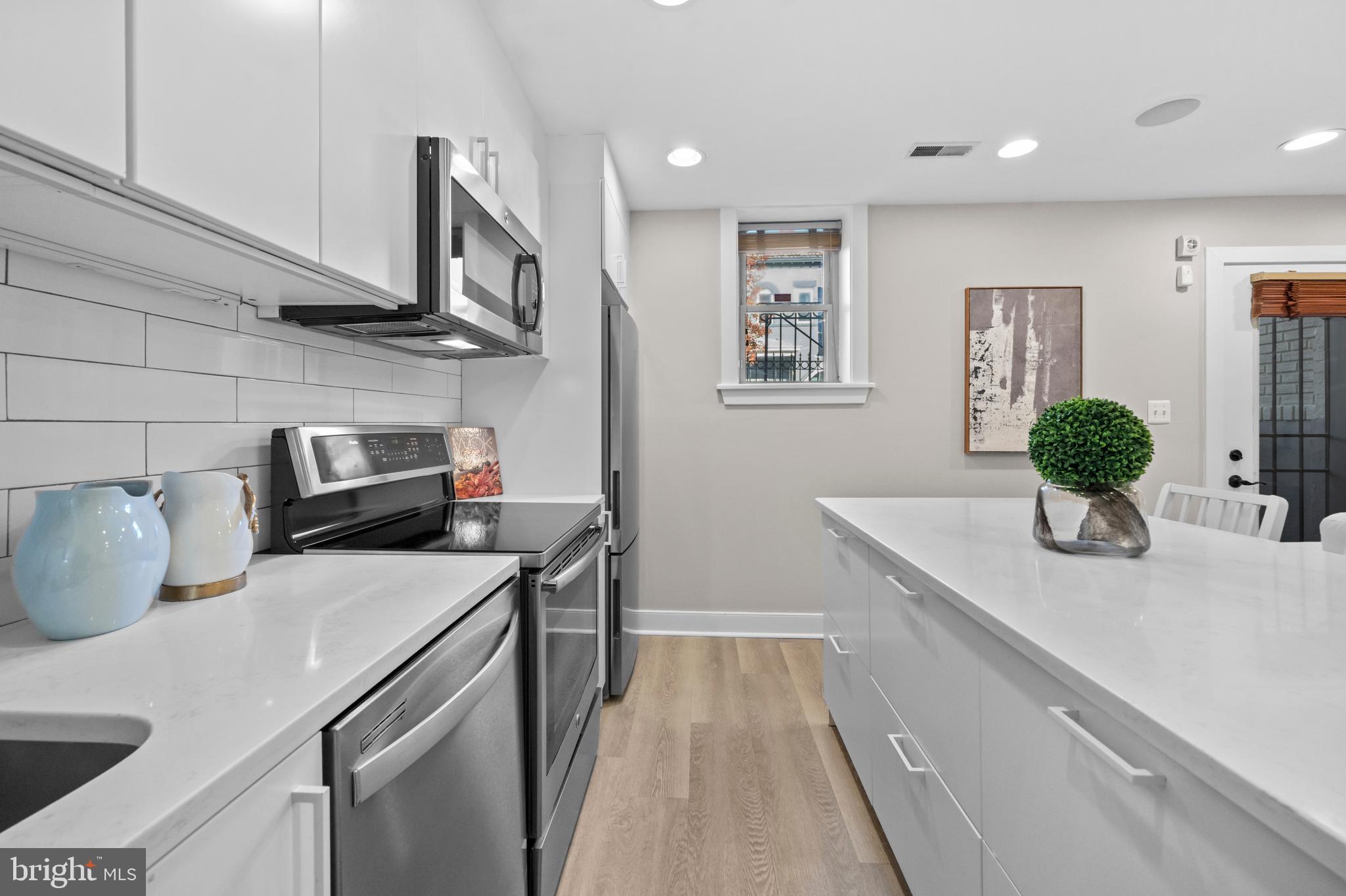 1718 1st Street Northwest, Unit 8 Washington, DC 20001 - Photo 6 of 25 a kitchen with sink cabinets and stove