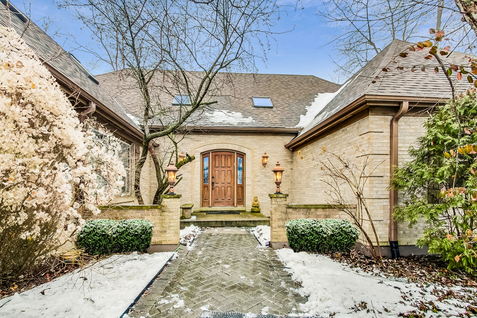 2330 Riverwoods Road Deerfield, IL 60015 - Photo 1 of 50 a front view of a house with garden