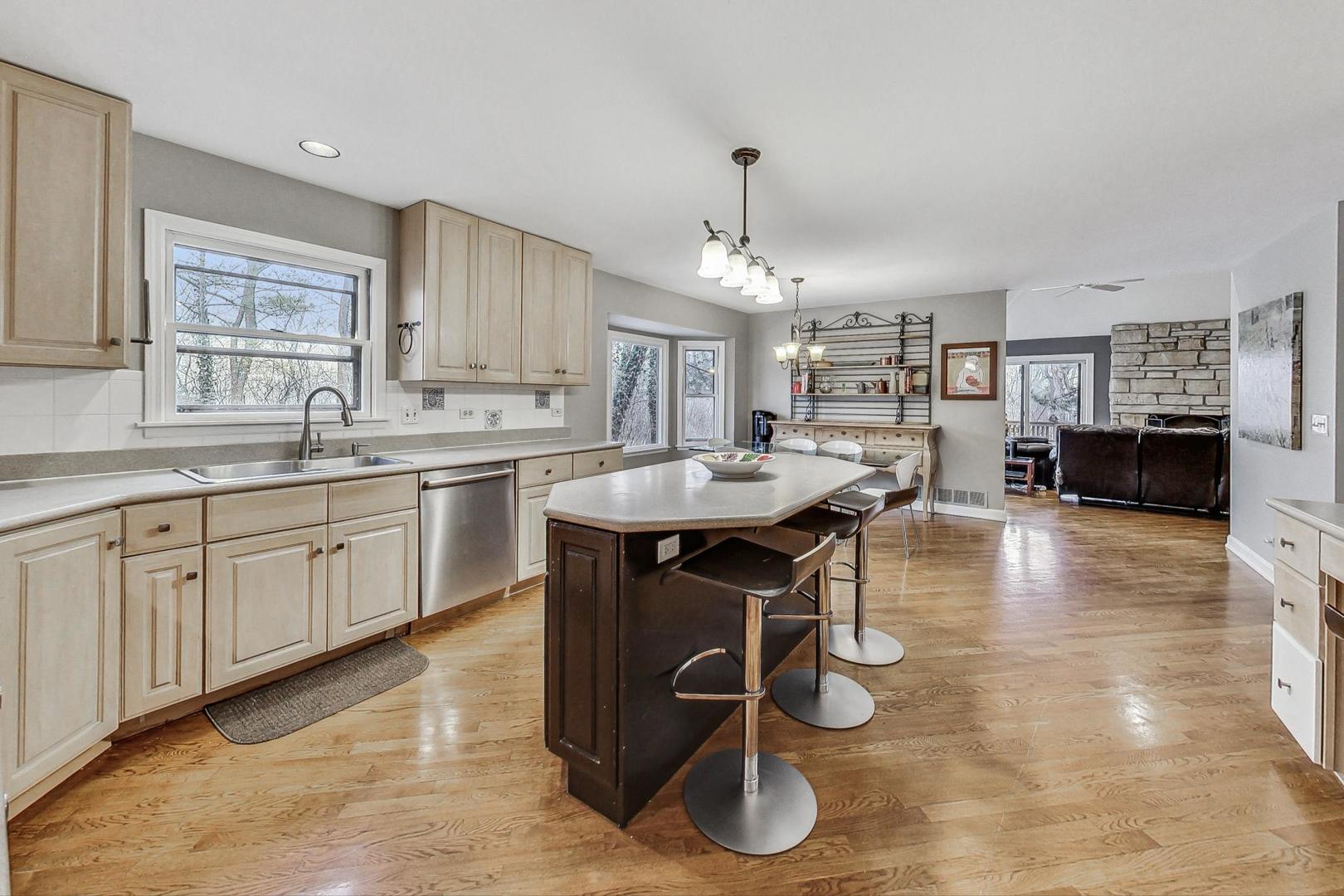 2330 Riverwoods Road Deerfield, IL 60015 - Photo 14 of 50 a kitchen with a sink counter and chairs