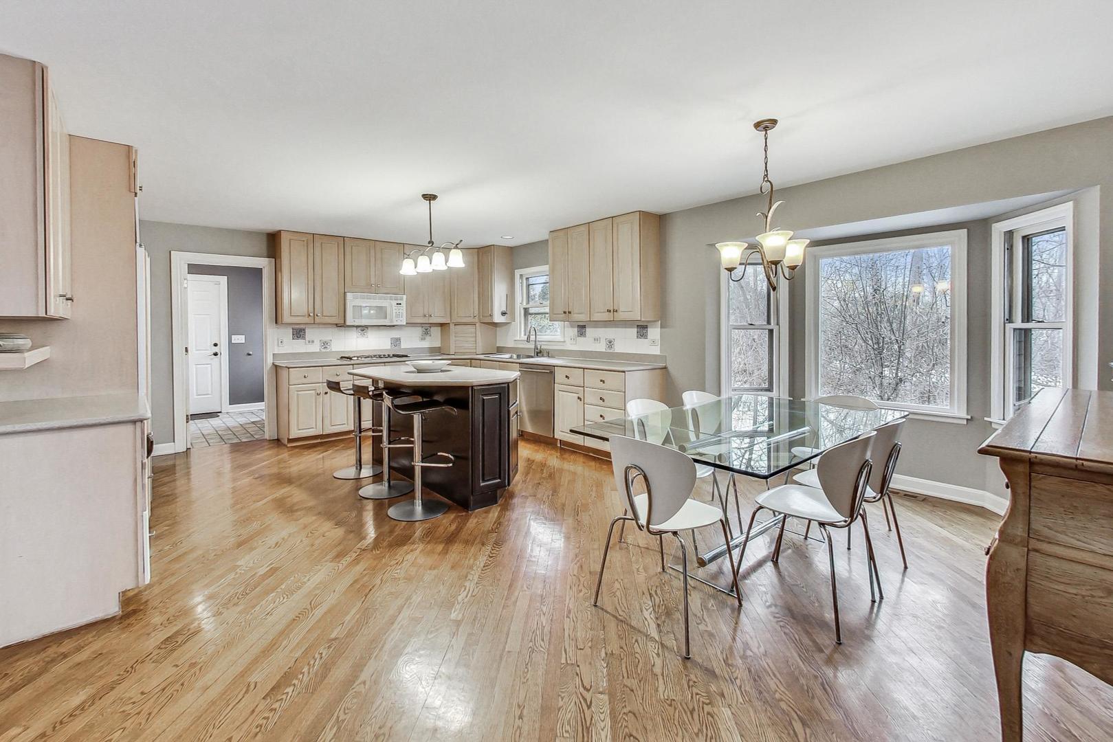 2330 Riverwoods Road Deerfield, IL 60015 - Photo 16 of 50 a view of a dining room and livingroom with furniture wooden floor a chandelier