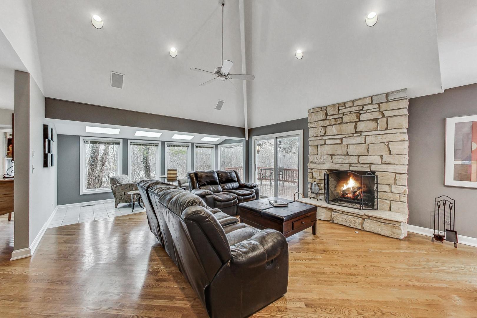 2330 Riverwoods Road Deerfield, IL 60015 - Photo 17 of 50 a living room with furniture a fireplace and a ceiling fan