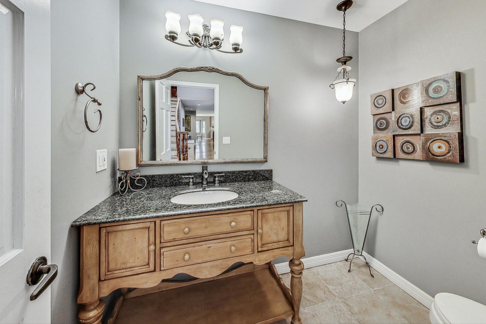 2330 Riverwoods Road Deerfield, IL 60015 - Photo 19 of 50 a bathroom with a granite countertop sink vanity mirror and toilet
