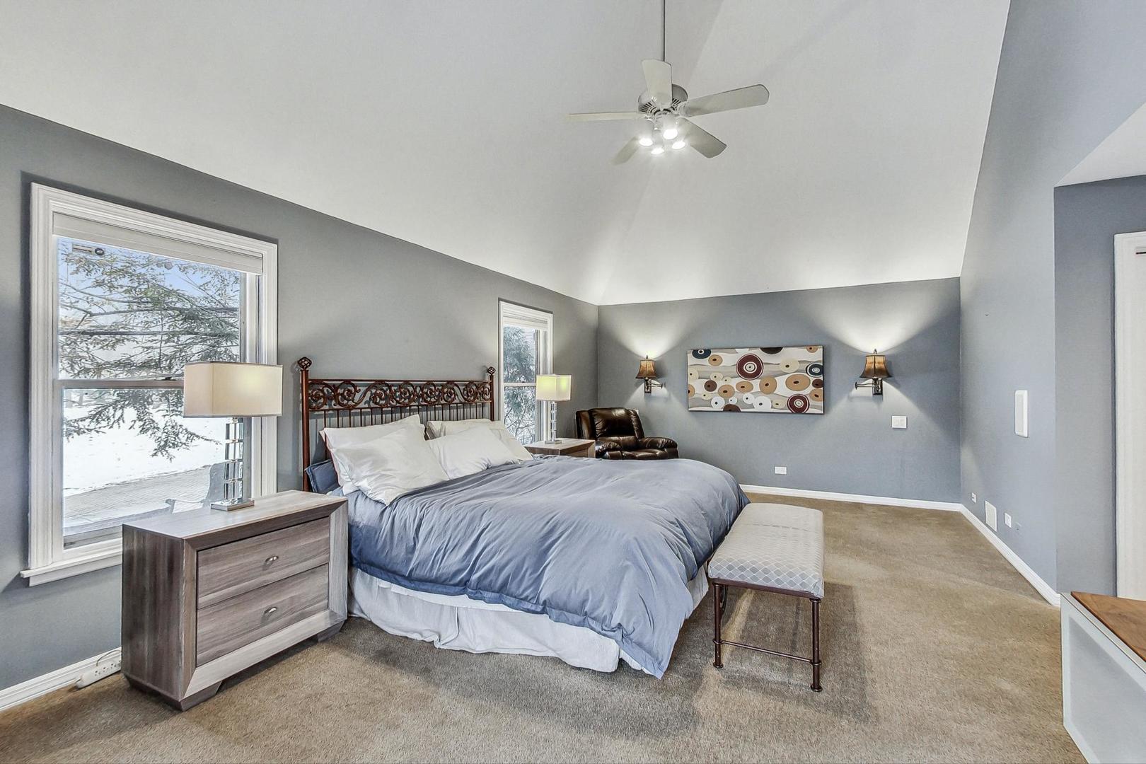 2330 Riverwoods Road Deerfield, IL 60015 - Photo 22 of 50 a bedroom with a bed and a chandelier