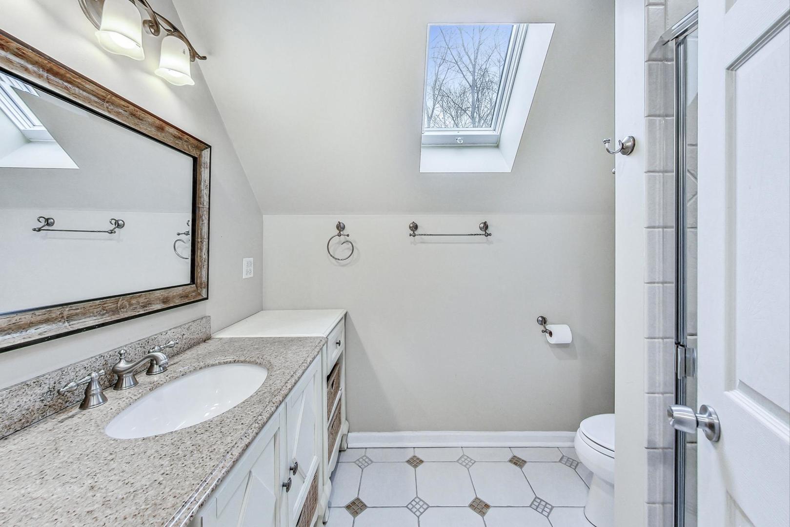 2330 Riverwoods Road Deerfield, IL 60015 - Photo 28 of 50 a bathroom with a granite countertop sink mirror vanity and toilet