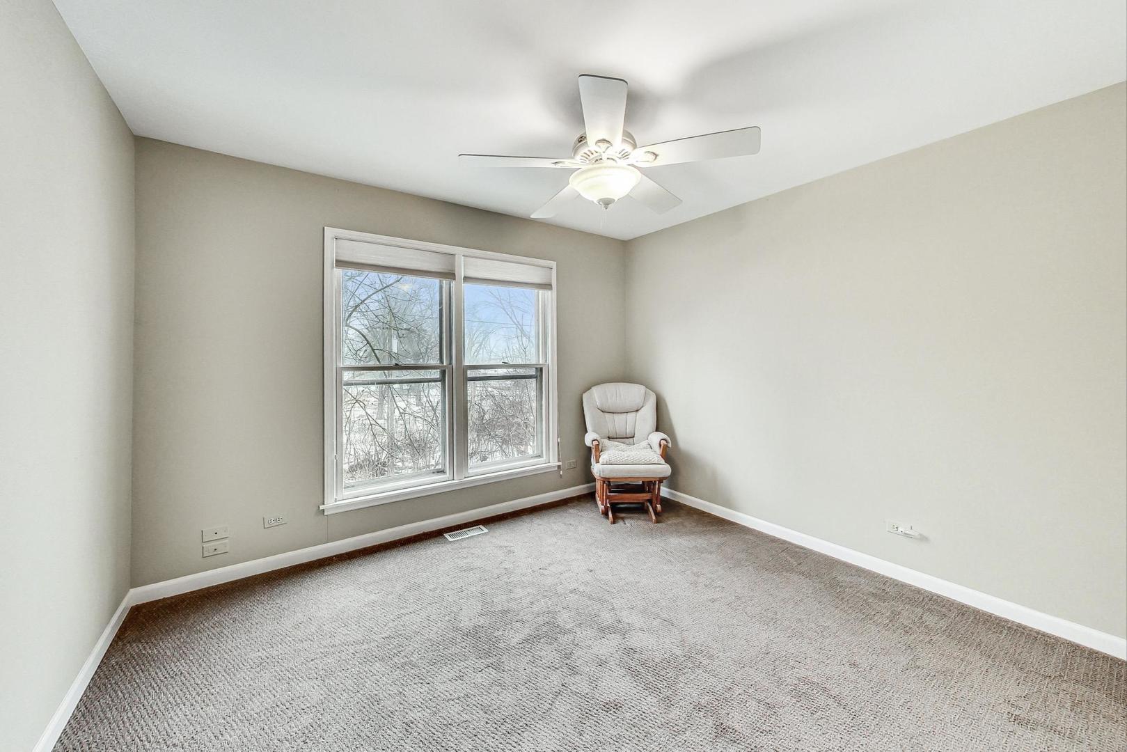 2330 Riverwoods Road Deerfield, IL 60015 - Photo 32 of 50 an empty room with chandelier fan and windows