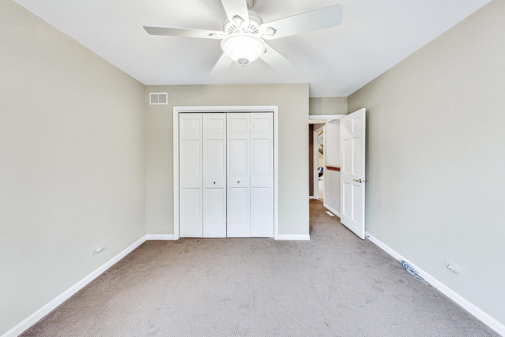 2330 Riverwoods Road Deerfield, IL 60015 - Photo 33 of 50 an empty room with closet and a ceiling fan