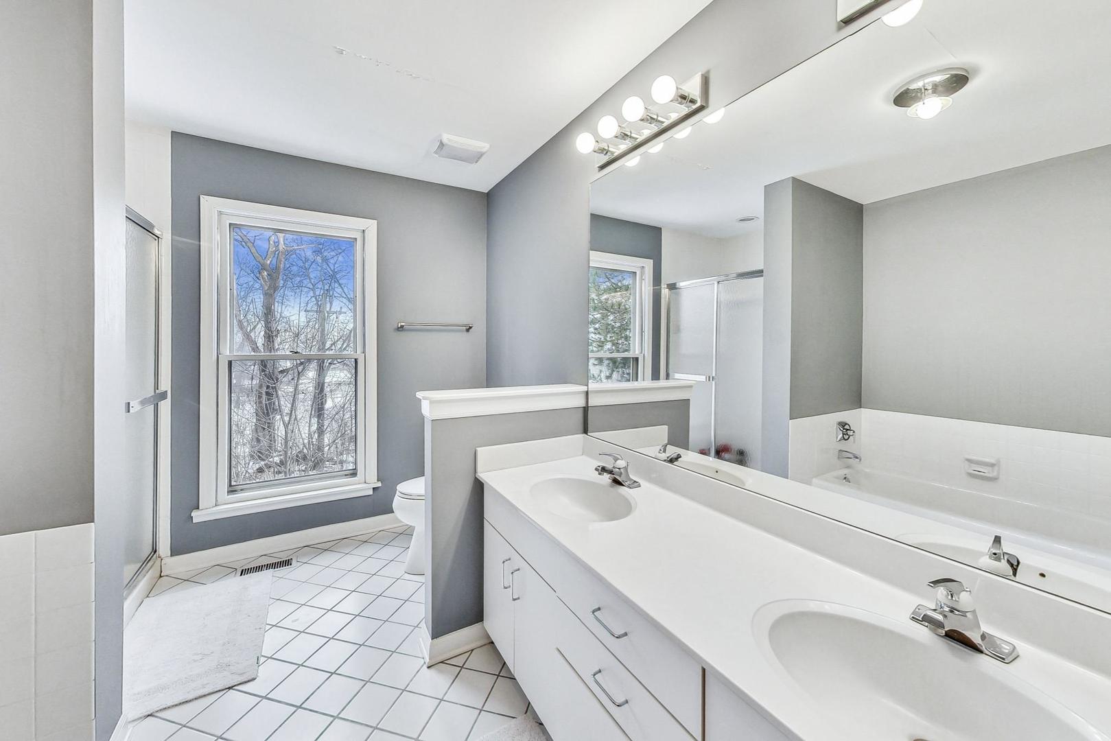 2330 Riverwoods Road Deerfield, IL 60015 - Photo 34 of 50 a spacious bathroom with a bathtub sink and mirror