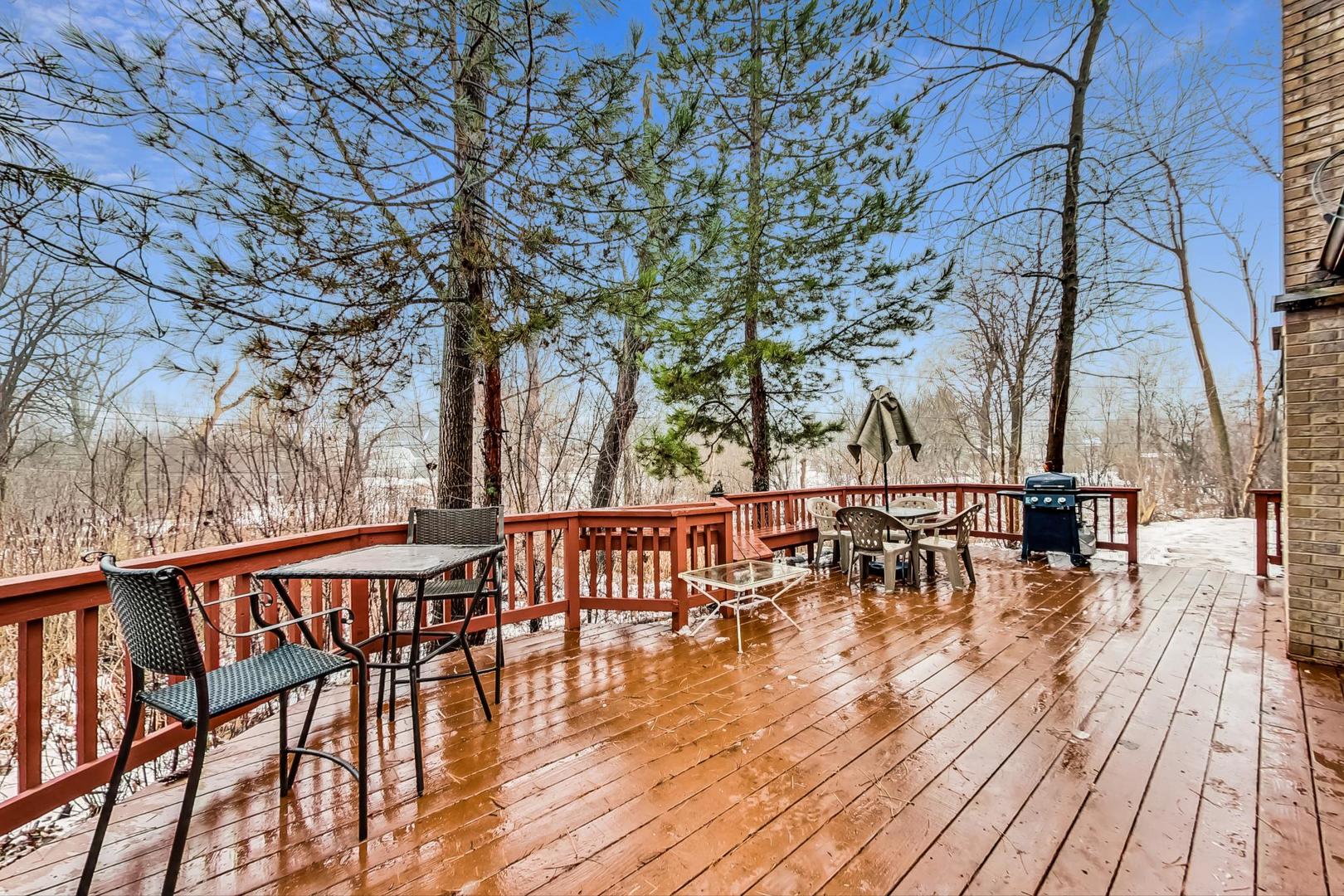 2330 Riverwoods Road Deerfield, IL 60015 - Photo 43 of 50 a view of a patio with table and chairs with wooden floor and fence