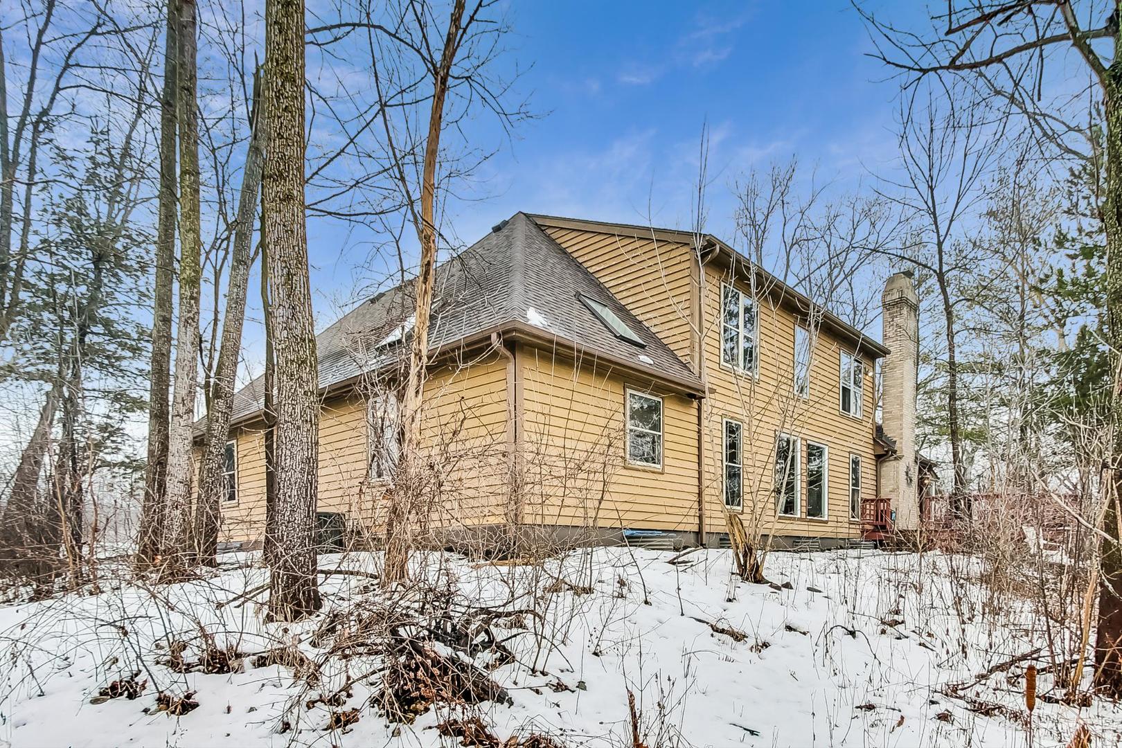 2330 Riverwoods Road Deerfield, IL 60015 - Photo 44 of 50 a front view of a house with a yard covered in snow