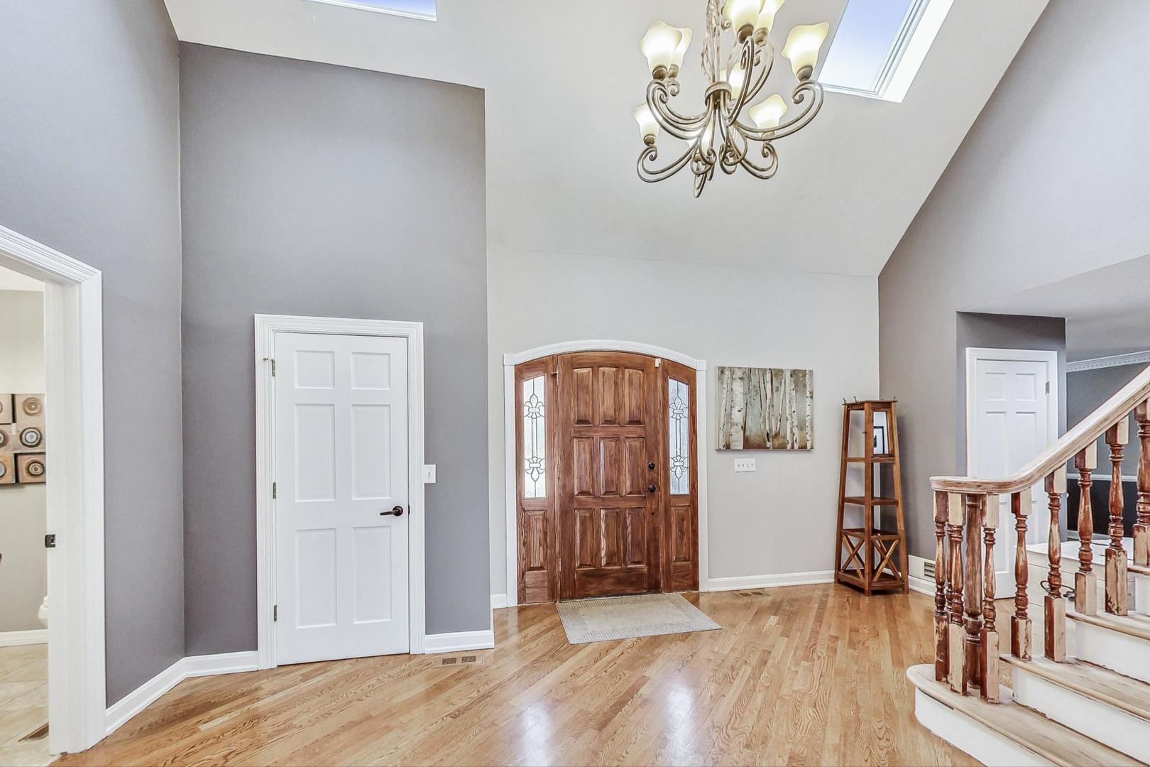 2330 Riverwoods Road Deerfield, IL 60015 - Photo 5 of 50 a view of a livingroom with wooden floor and a chandelier