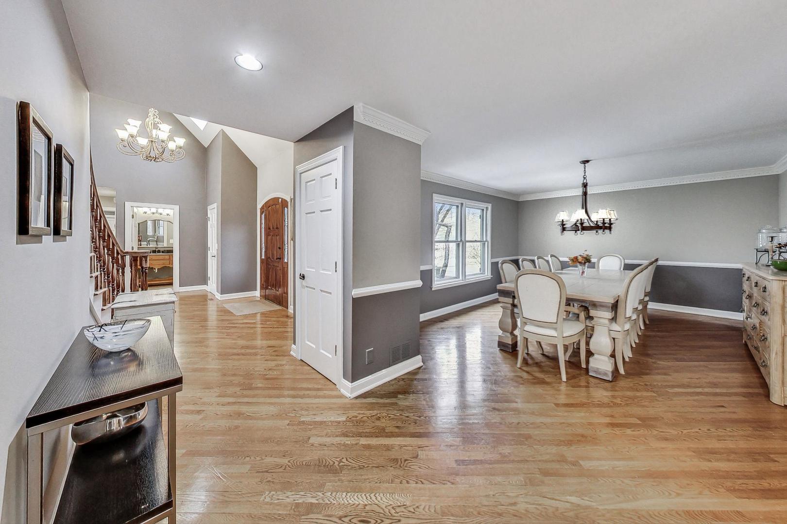 2330 Riverwoods Road Deerfield, IL 60015 - Photo 8 of 50 a view of a dining room with furniture a chandelier and wooden floor
