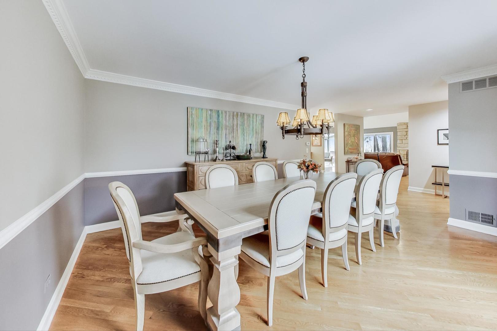 2330 Riverwoods Road Deerfield, IL 60015 - Photo 10 of 50 a dining room with furniture a chandelier and wooden floor