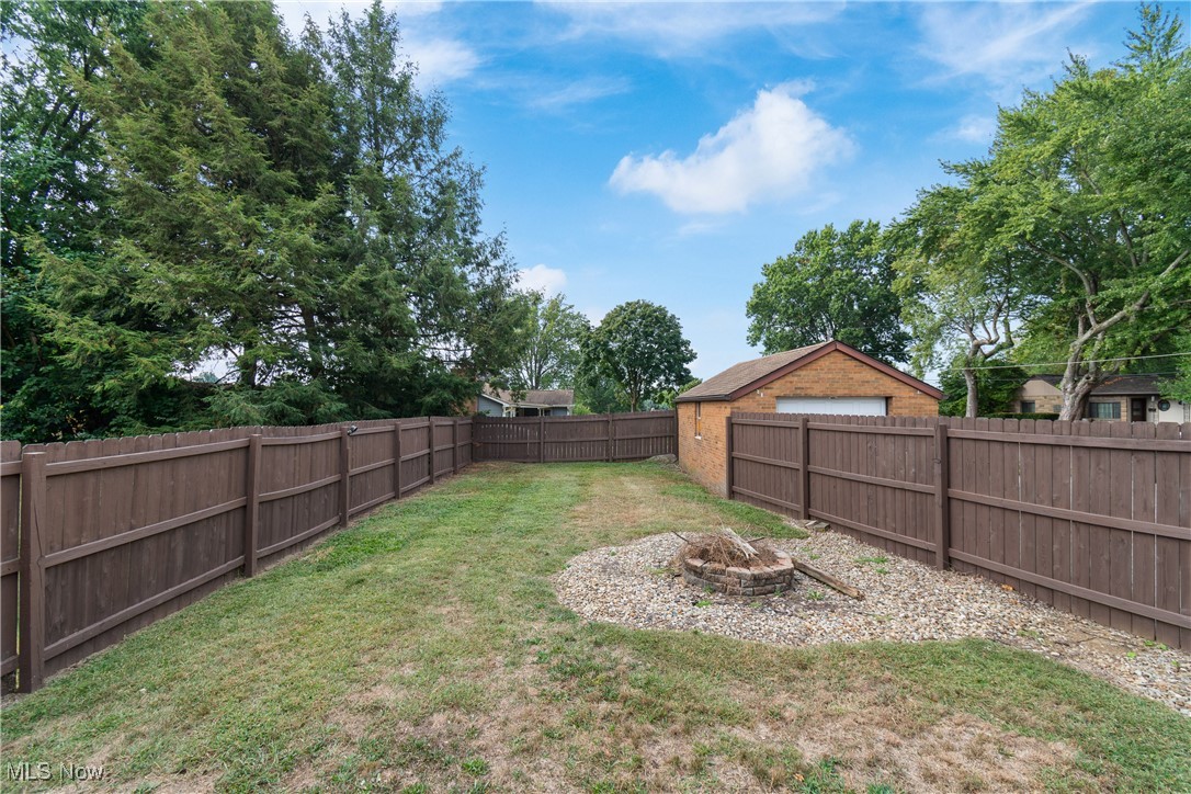 4560 7th Street Northwest Canton, OH 44708 - Photo 23 of 28 Fenced backyard featuring an outdoor fire pit
