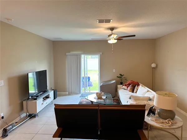 a room with a table chairs and a flat screen tv