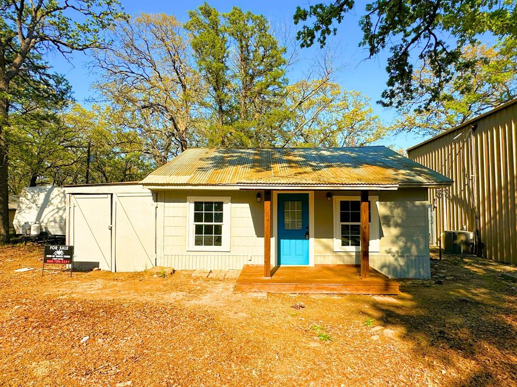 310 Cedar Point Circle Gordonville, TX 76245 - Photo 1 of 9 a view of a white house with a swimming pool