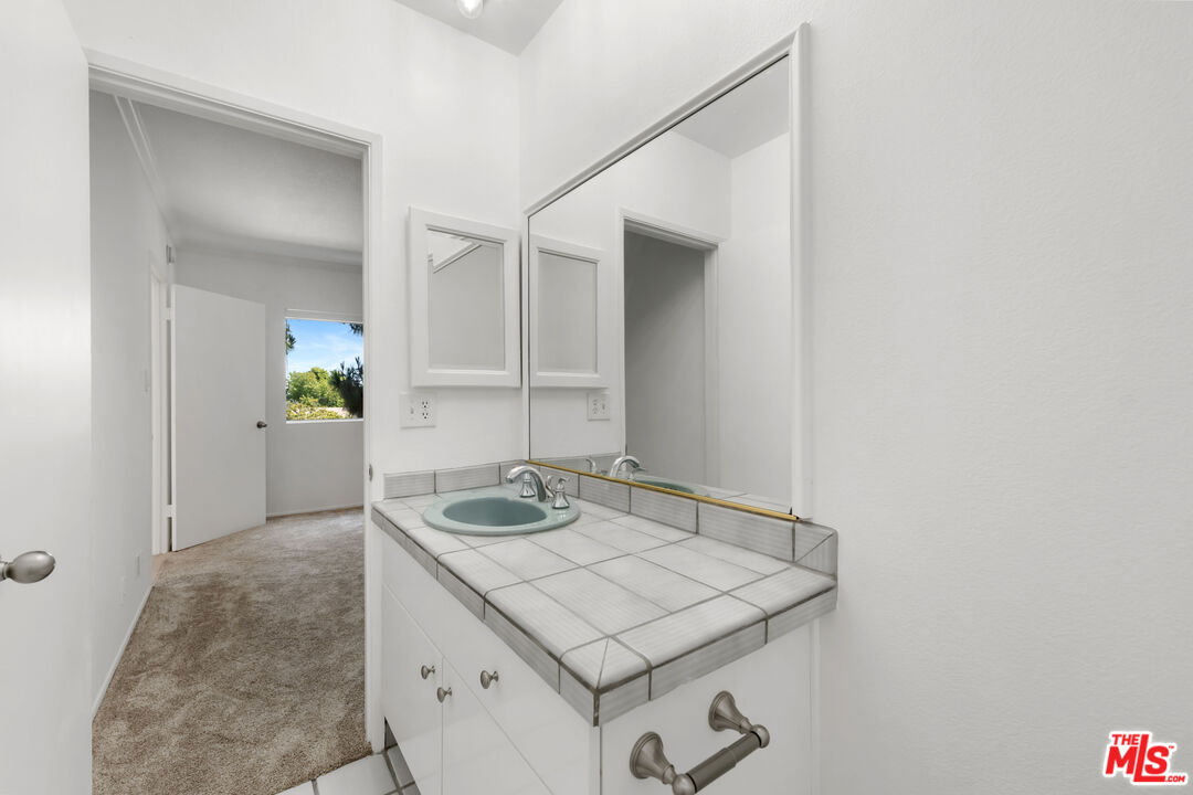 222 7th Street, Unit 301 Santa Monica, CA 90402 - Photo 24 of 55 a bathroom with a sink and a mirror