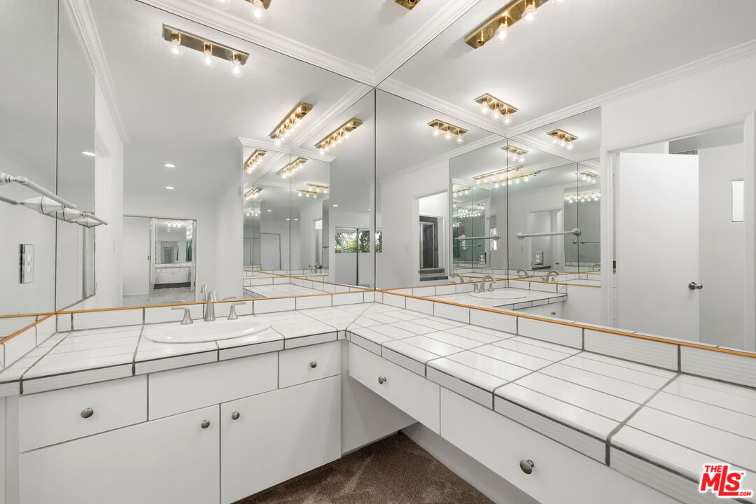 222 7th Street, Unit 301 Santa Monica, CA 90402 - Photo 33 of 55 a large white bathroom with a large mirror vanity and shower