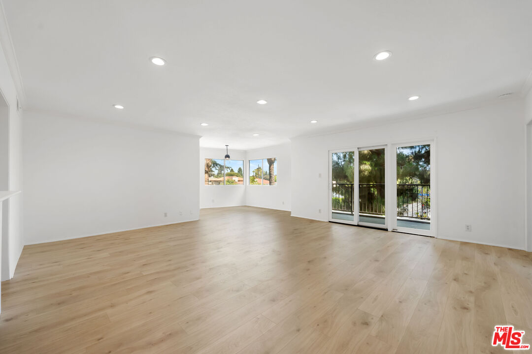 222 7th Street, Unit 301 Santa Monica, CA 90402 - Photo 9 of 55 a view of an empty room with wooden floor and a window