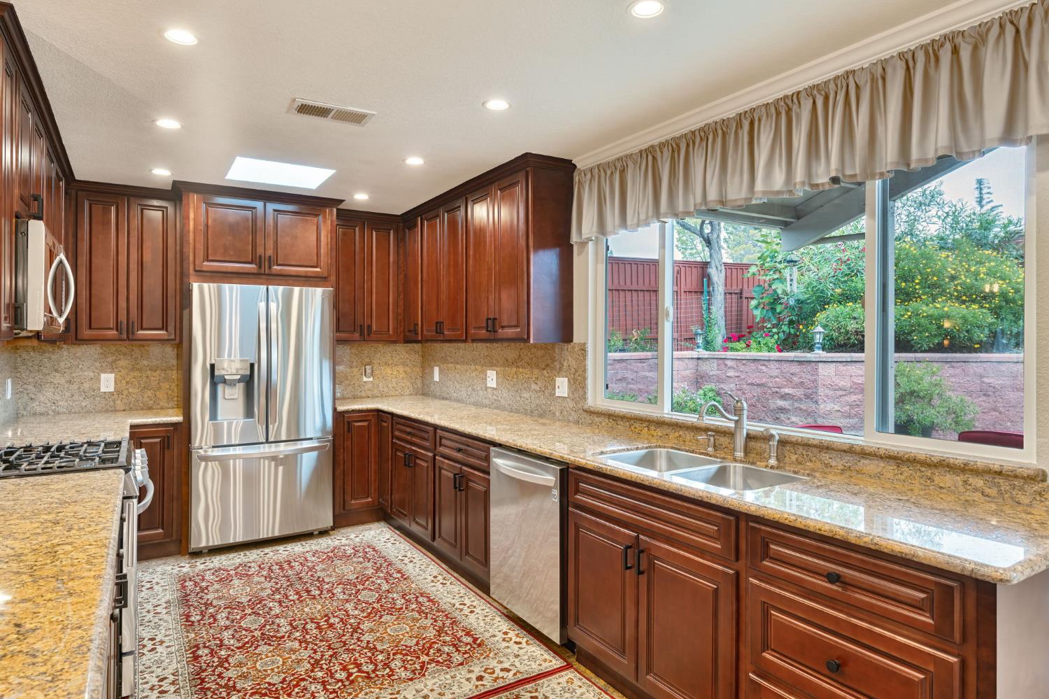 6003 Telesco Way Carmichael, CA 95608 - Photo 13 of 47 a kitchen with stainless steel appliances granite countertop a sink refrigerator and cabinets