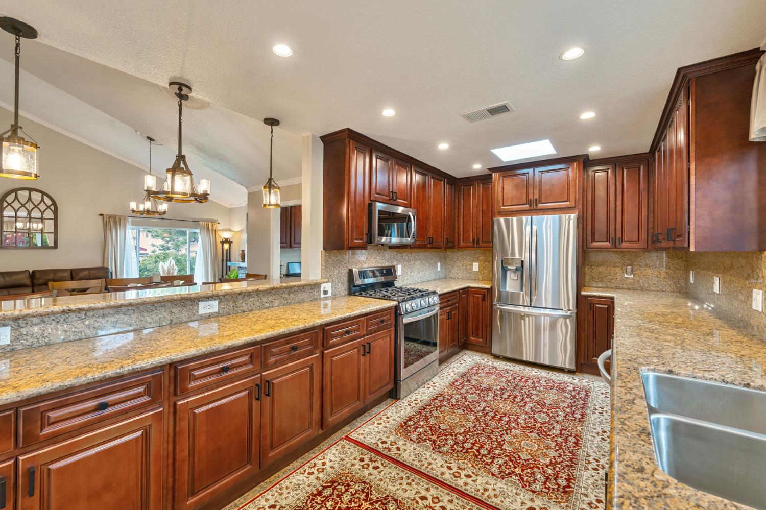 6003 Telesco Way Carmichael, CA 95608 - Photo 15 of 47 a large kitchen with granite countertop a large counter top stainless steel appliances and cabinets