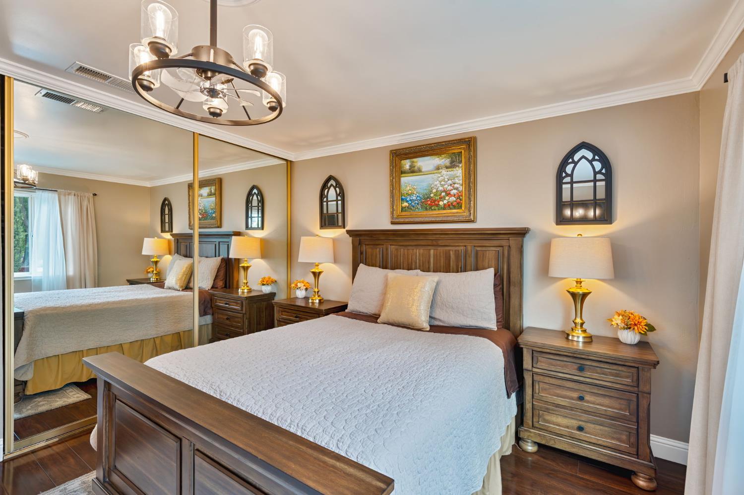 6003 Telesco Way Carmichael, CA 95608 - Photo 19 of 47 a bedroom with a bed and a chandelier