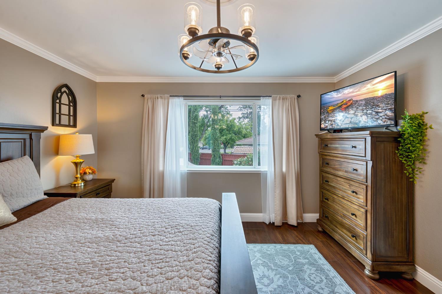 6003 Telesco Way Carmichael, CA 95608 - Photo 20 of 47 a bedroom with a bed and a flat tv screen on dresser