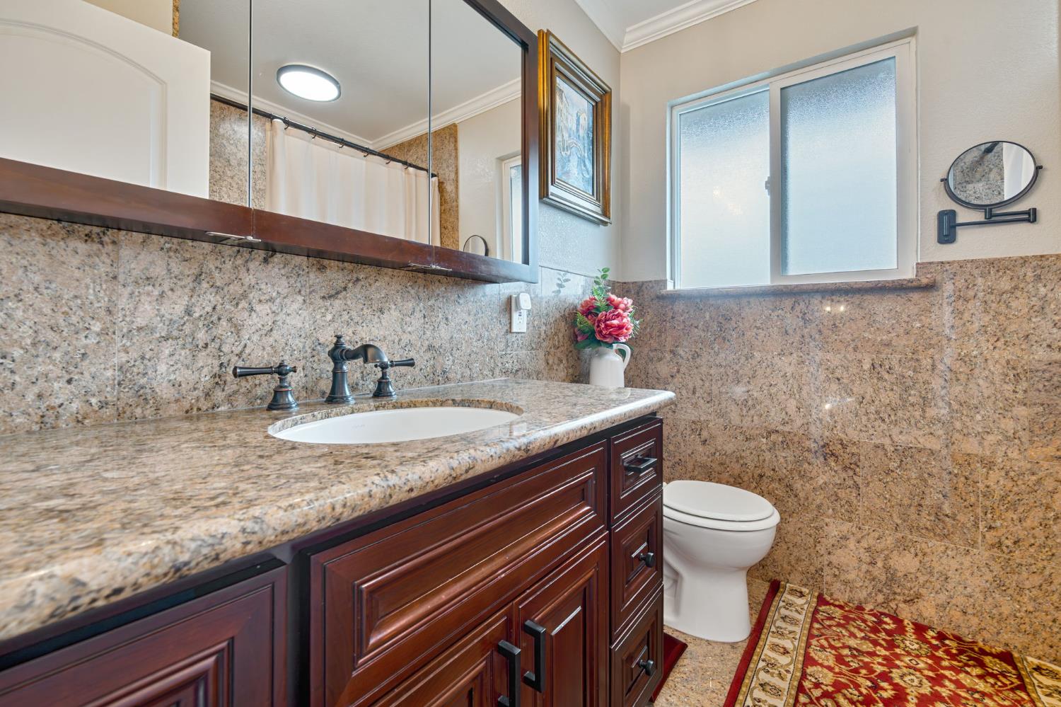 6003 Telesco Way Carmichael, CA 95608 - Photo 29 of 47 a bathroom with a granite countertop toilet sink and mirror