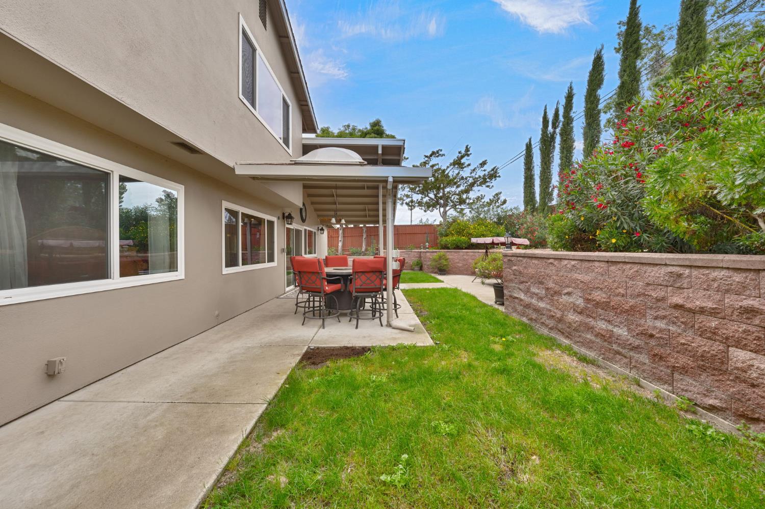 6003 Telesco Way Carmichael, CA 95608 - Photo 41 of 47 a view of a backyard with table and chairs potted plants and wooden fence
