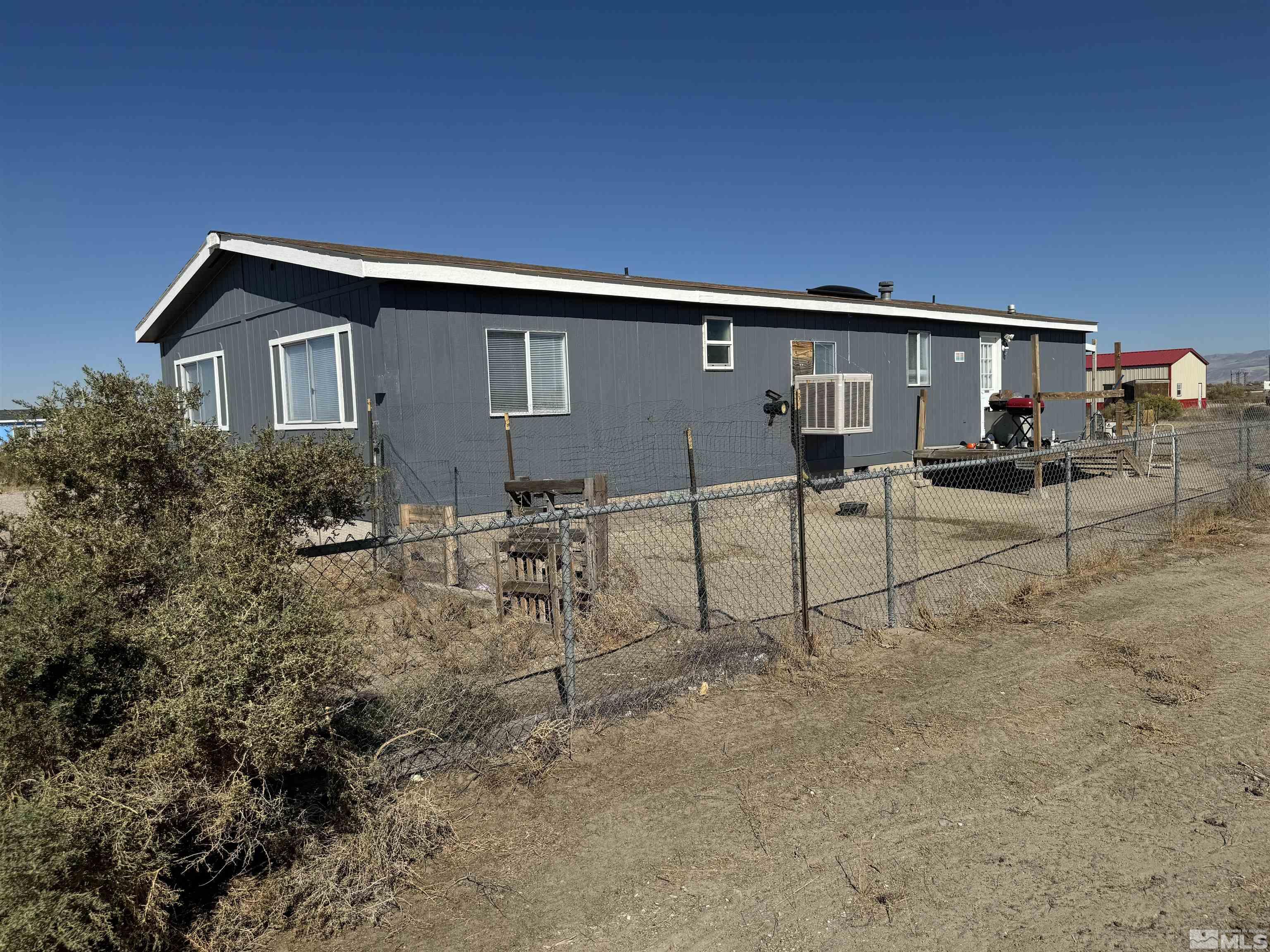 5500 Mission Road Fallon, NV 89406 - Photo 13 of 15 a backyard of a house with table and chairs